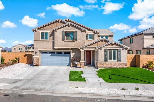 craftsman inspired home with stucco siding, concrete driveway, fence, a garage, and stone siding