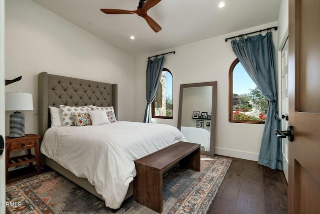 bedroom with vaulted ceiling, recessed lighting, wood finished floors, and baseboards