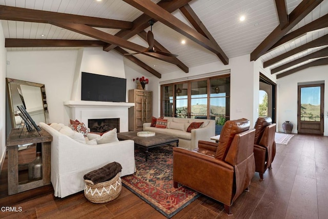 living room featuring vaulted ceiling with beams, ceiling fan, recessed lighting, a fireplace, and dark wood finished floors