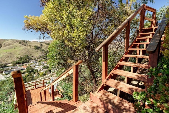 exterior space featuring stairs and a wooden deck