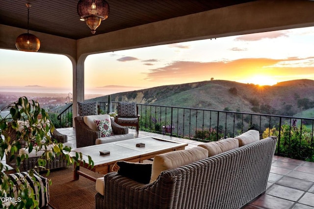 balcony featuring an outdoor hangout area, a patio area, and a mountain view