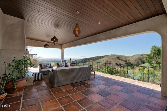 view of patio / terrace with a mountain view and an outdoor living space