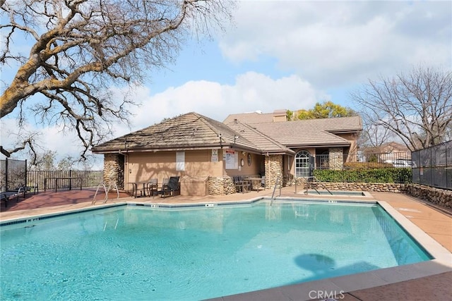 pool featuring fence and a patio