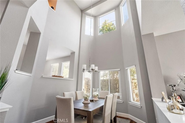 dining area with a healthy amount of sunlight, baseboards, and a notable chandelier