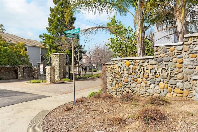 community sign featuring a gate