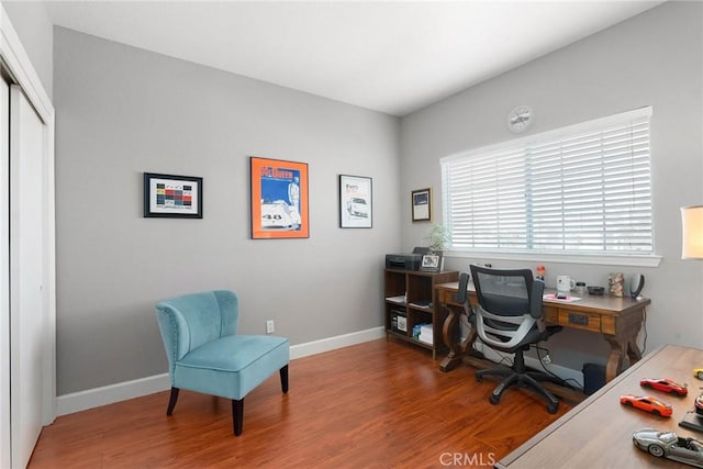 office featuring baseboards and wood finished floors