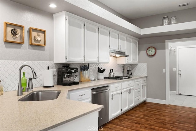 kitchen with visible vents, appliances with stainless steel finishes, under cabinet range hood, white cabinetry, and a sink