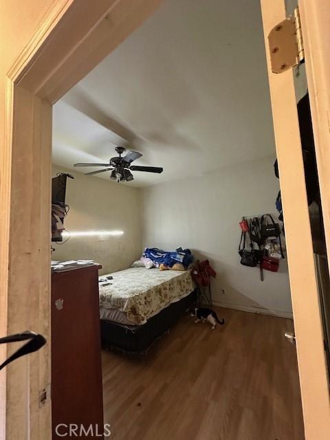 bedroom with ceiling fan and wood finished floors