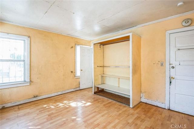 unfurnished bedroom featuring ornamental molding and wood finished floors