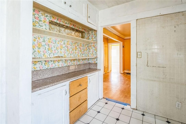 kitchen featuring ornamental molding, light countertops, light floors, white cabinetry, and open shelves