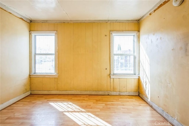 empty room with light wood-type flooring and baseboards