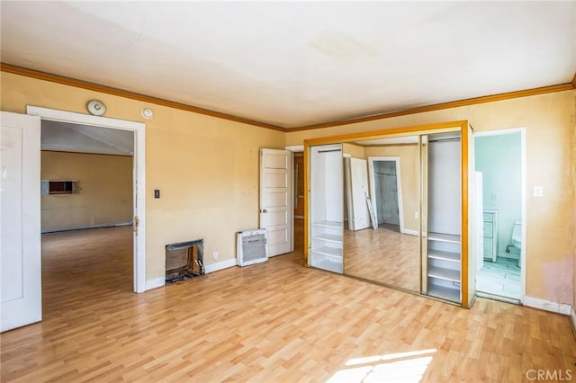 unfurnished bedroom with ornamental molding, baseboards, and light wood finished floors