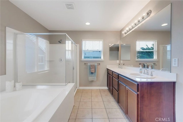 full bath with plenty of natural light, a sink, and tile patterned floors