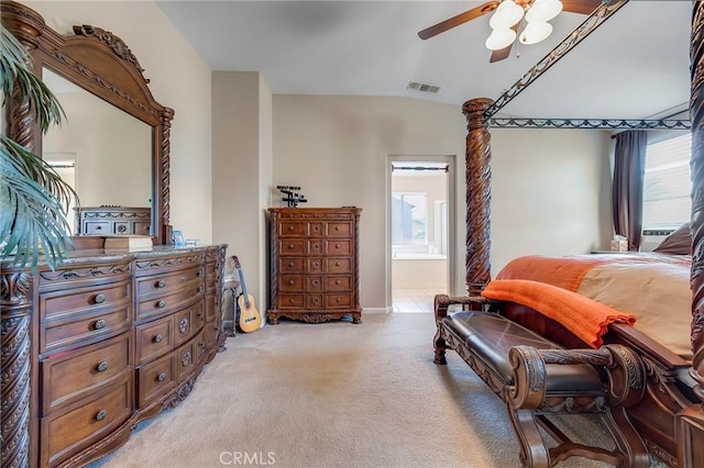 bedroom featuring light carpet, multiple windows, visible vents, and vaulted ceiling