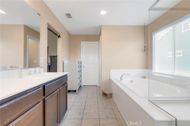 bathroom with recessed lighting, visible vents, vanity, tile patterned flooring, and a bath