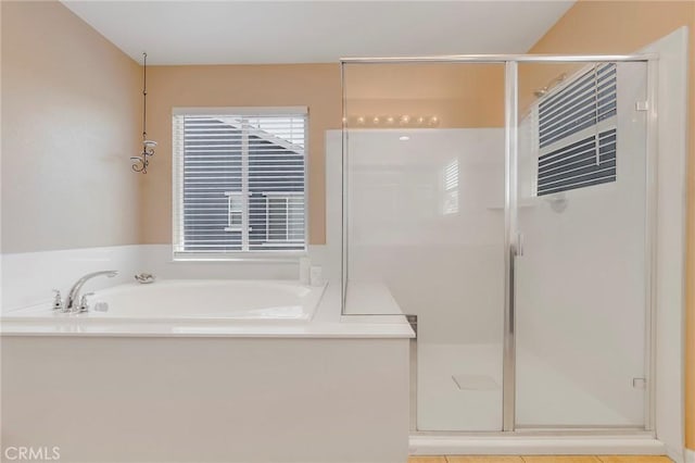 full bathroom featuring a stall shower and a bath