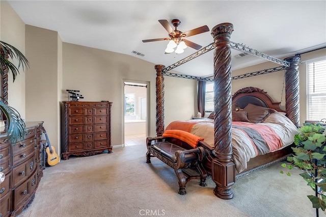 bedroom featuring a ceiling fan, connected bathroom, visible vents, and light colored carpet