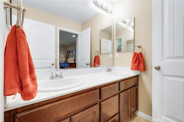 full bathroom featuring tile patterned floors, a sink, and double vanity