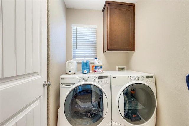 washroom with independent washer and dryer and cabinet space