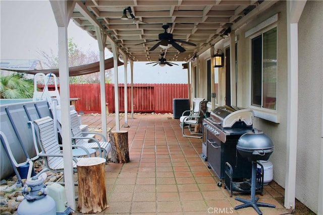 view of patio / terrace with ceiling fan and fence