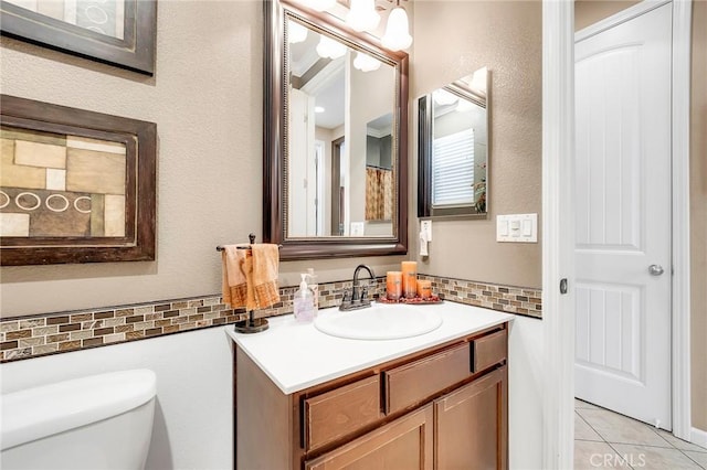 full bath featuring vanity, toilet, and tile patterned floors