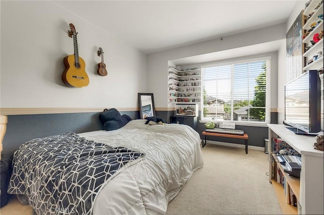 bedroom featuring light carpet and baseboards