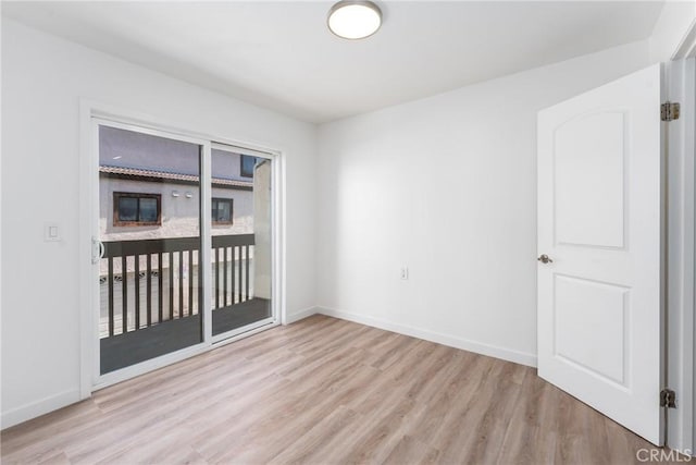 empty room with baseboards and wood finished floors