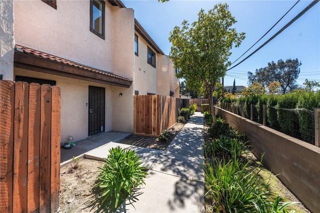 exterior space featuring a fenced backyard, a patio, and stucco siding