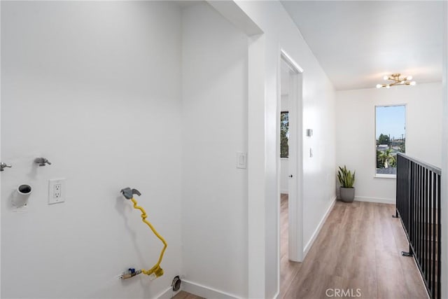 corridor with light wood-style flooring and baseboards