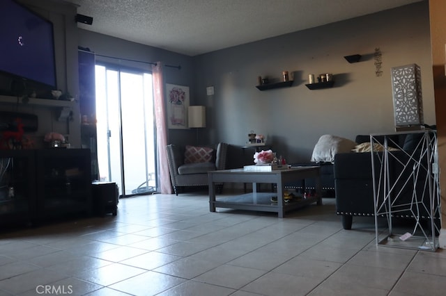 living room with tile patterned flooring and a textured ceiling