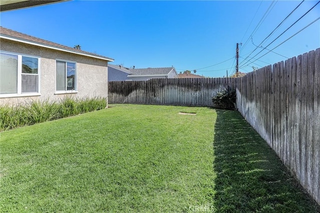 view of yard with a fenced backyard