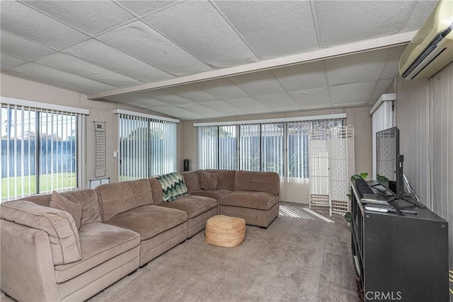 living area with an AC wall unit and carpet flooring