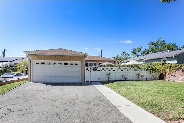 single story home with an attached garage, fence, driveway, stucco siding, and a front yard