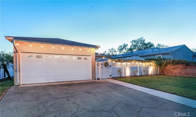 garage with fence and aphalt driveway