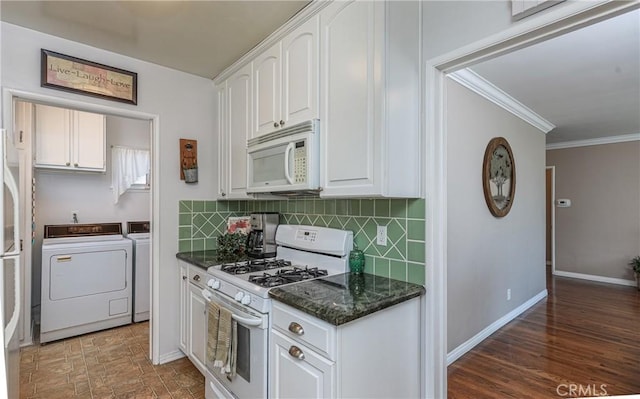 kitchen featuring white appliances, white cabinetry, separate washer and dryer, and decorative backsplash