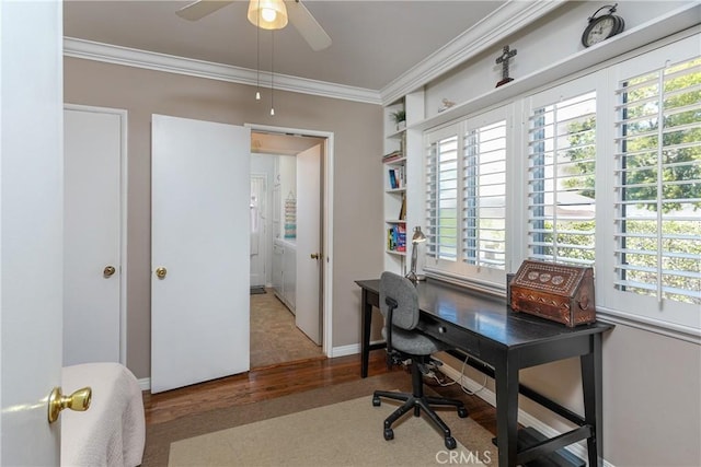 office featuring baseboards, ceiling fan, wood finished floors, and crown molding