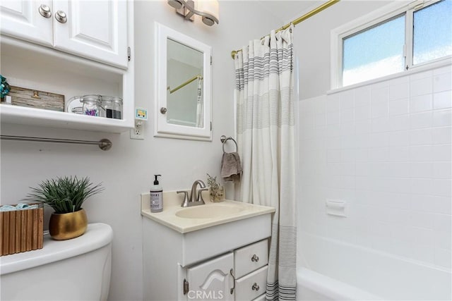 bathroom with toilet, shower / bath combination with curtain, and vanity