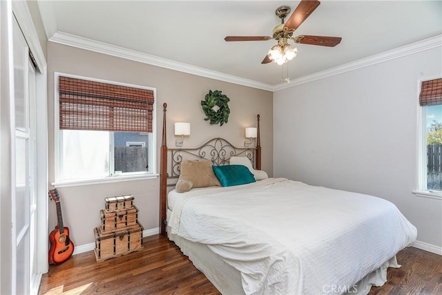 bedroom with ceiling fan, crown molding, baseboards, and wood finished floors