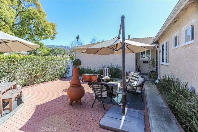 view of patio / terrace with outdoor dining area and fence