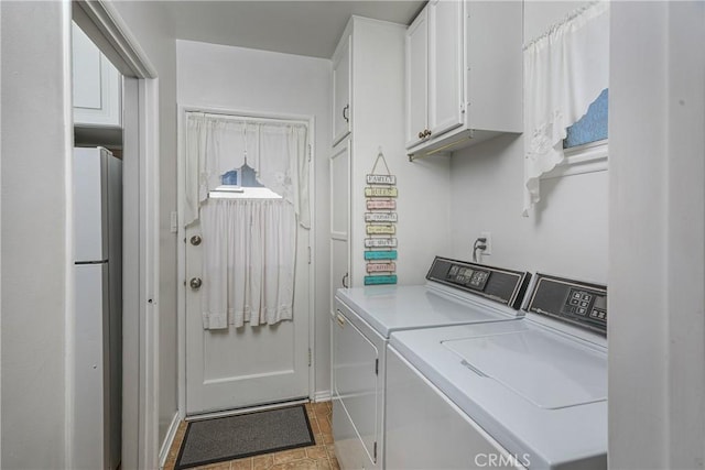 laundry area with washer and clothes dryer and cabinet space