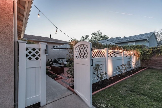 view of gate featuring a yard and fence