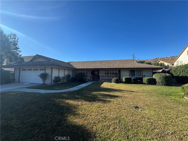 ranch-style house featuring a garage, concrete driveway, and a front yard