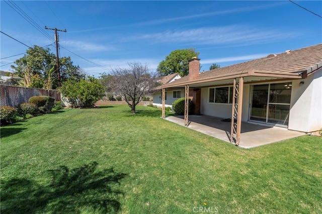 view of yard featuring a patio and fence