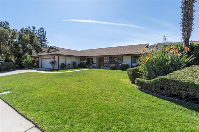 single story home with a garage, a front yard, driveway, and stucco siding