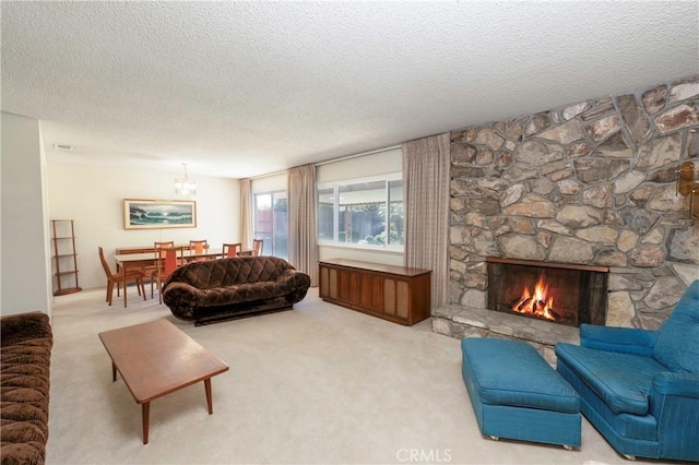 carpeted living area featuring a fireplace and a textured ceiling