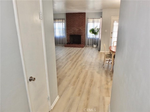 living area with light wood-type flooring and a fireplace