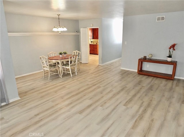 dining room featuring baseboards, visible vents, an inviting chandelier, and wood finished floors