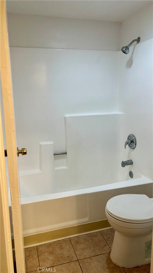 full bathroom with tile patterned flooring, shower / bathing tub combination, and toilet