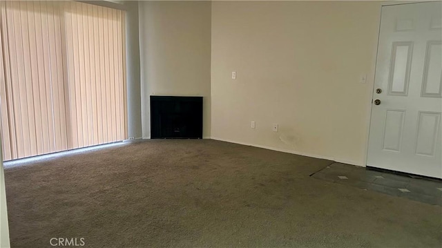 unfurnished living room featuring dark carpet