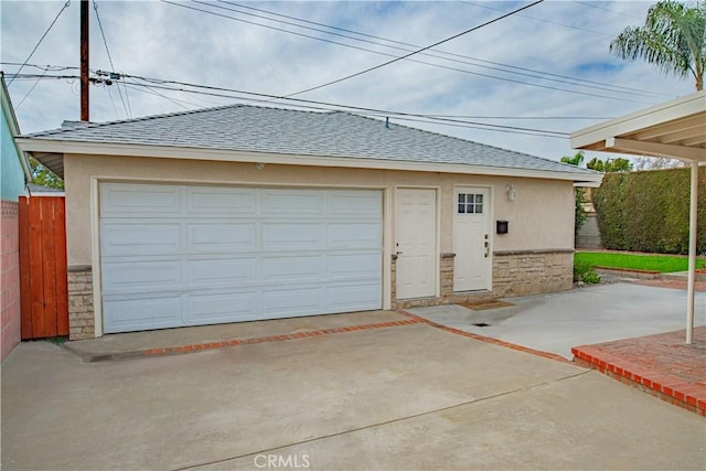 detached garage featuring fence